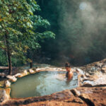 woman resting in an hot spring in oregon