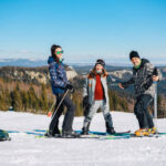 Older man with his family and friends having fun on the mountain.