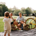 Why Spring Is the Best Season for Family Outdoor Time Happy family with two children in the forest